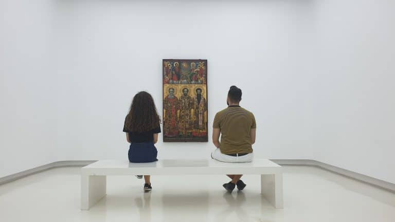 Two people watching a gallery artwork