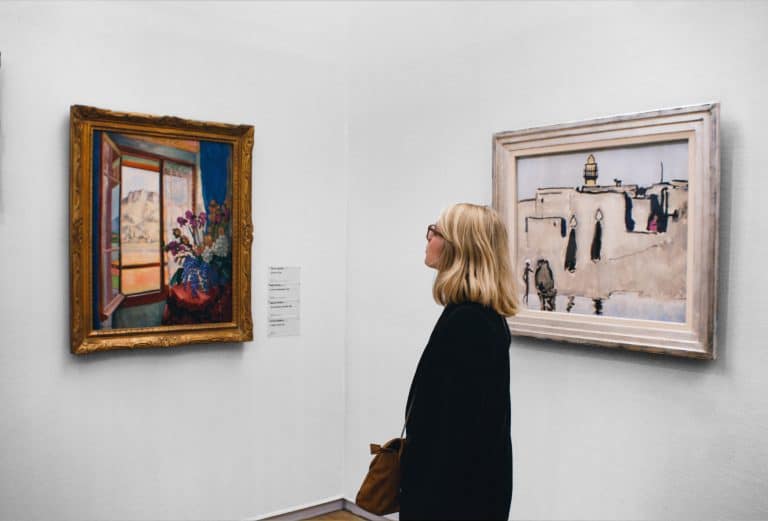 Paintings and visitor in a gallery