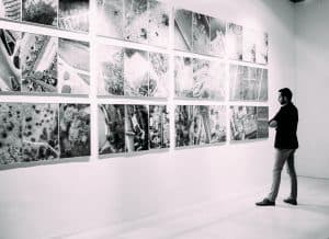 Man watching artworks in a gallery