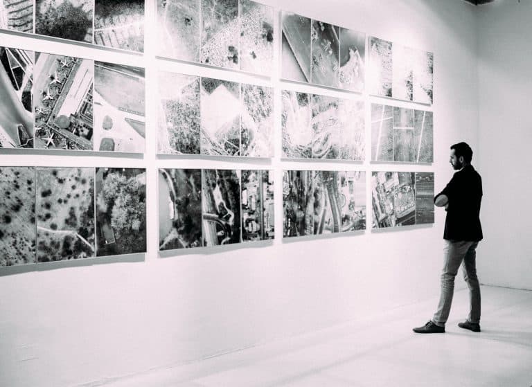 Man watching artworks in a gallery