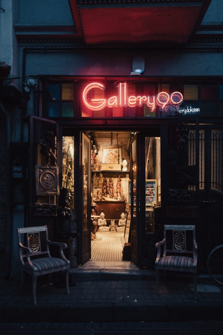 a store front with two chairs outside of it