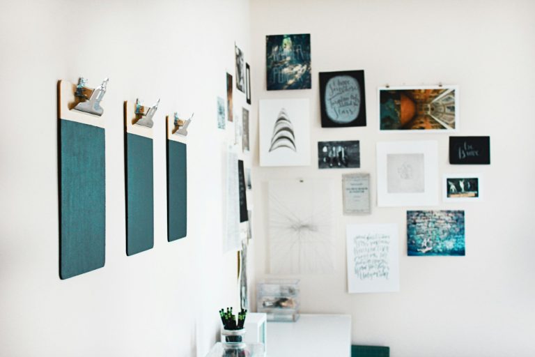 three green clipboards on wall