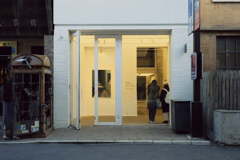 a couple of people that are standing outside of a building