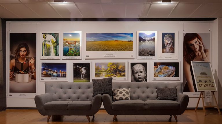 a living room with two couches and pictures on the wall